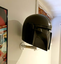 Load image into Gallery viewer, Side view of my Mando helmet as it hangs on my wall.

